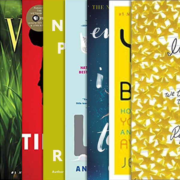 A row of seven book covers side by side, in green, red, olive, pale blue, navy, yellow and gold star patterns