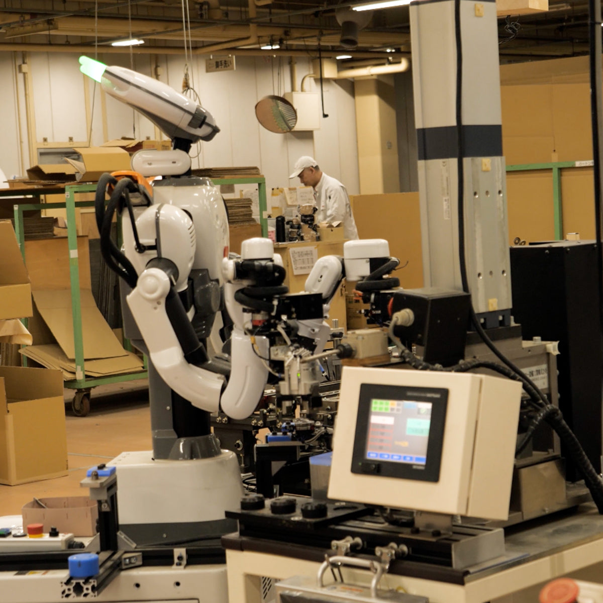 Robots work alongside humans at a Karimoku furniture factory