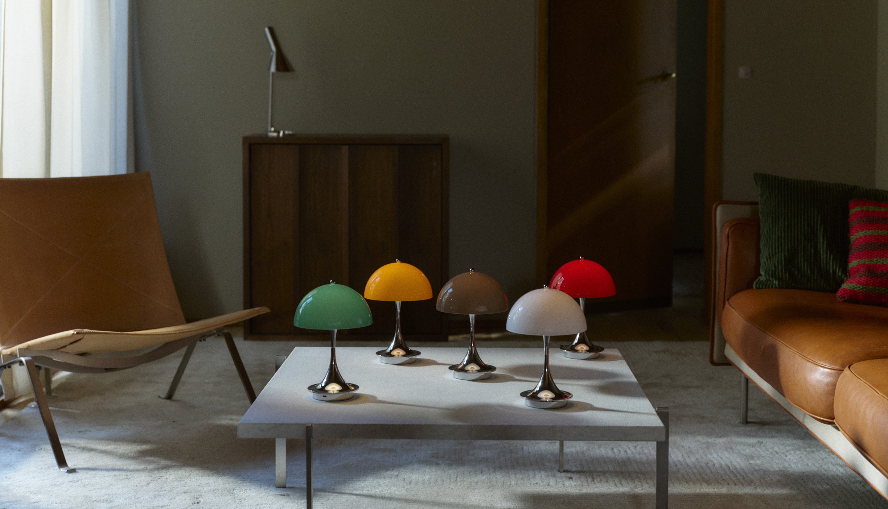 Colorful table lamps on a coffee table in a modern living room.