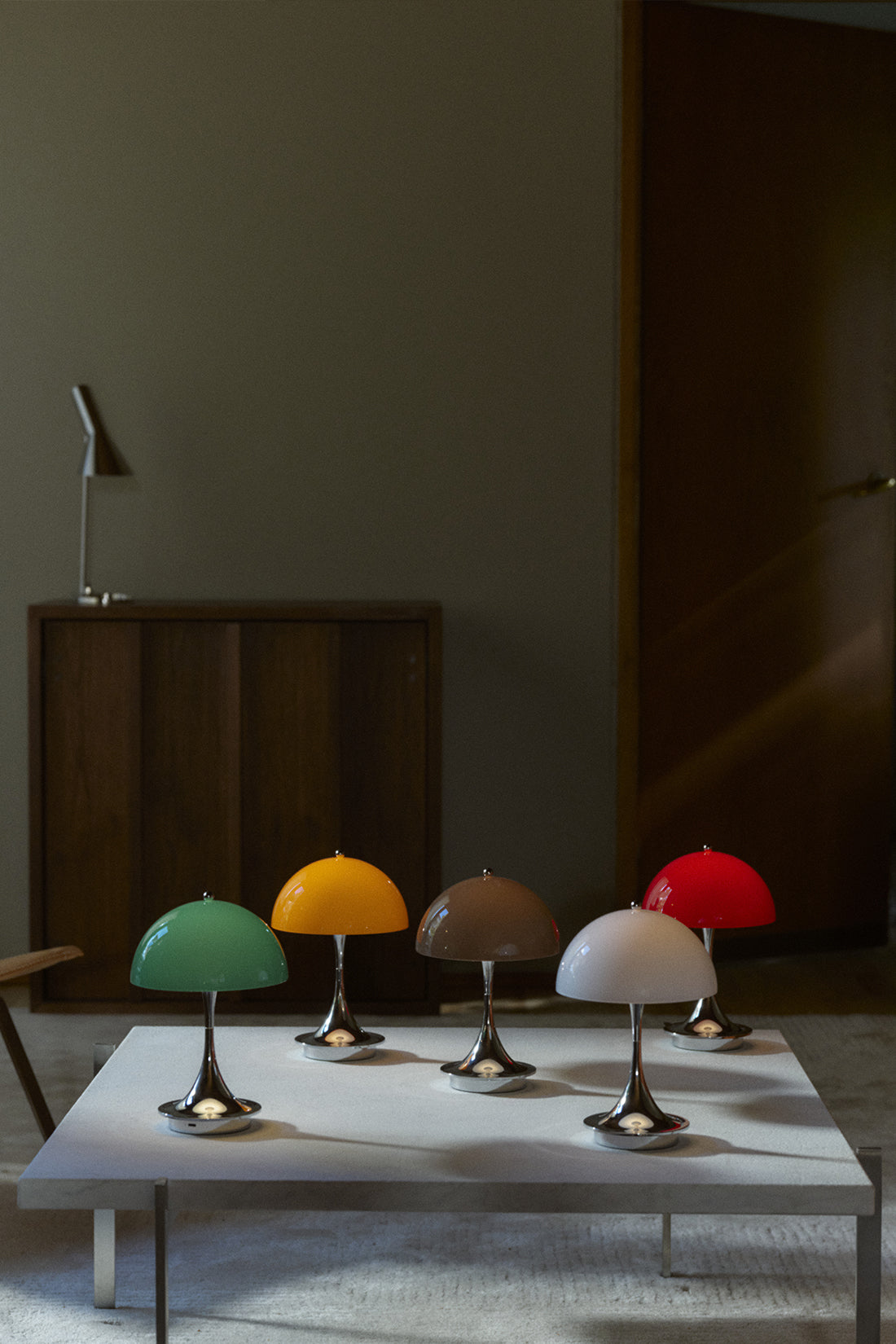 Five colorful lamps on a table with a dark background