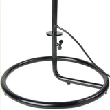 Close-up of a black metal lamp base, a round tubular ring with an upright pole, wing screw and cord