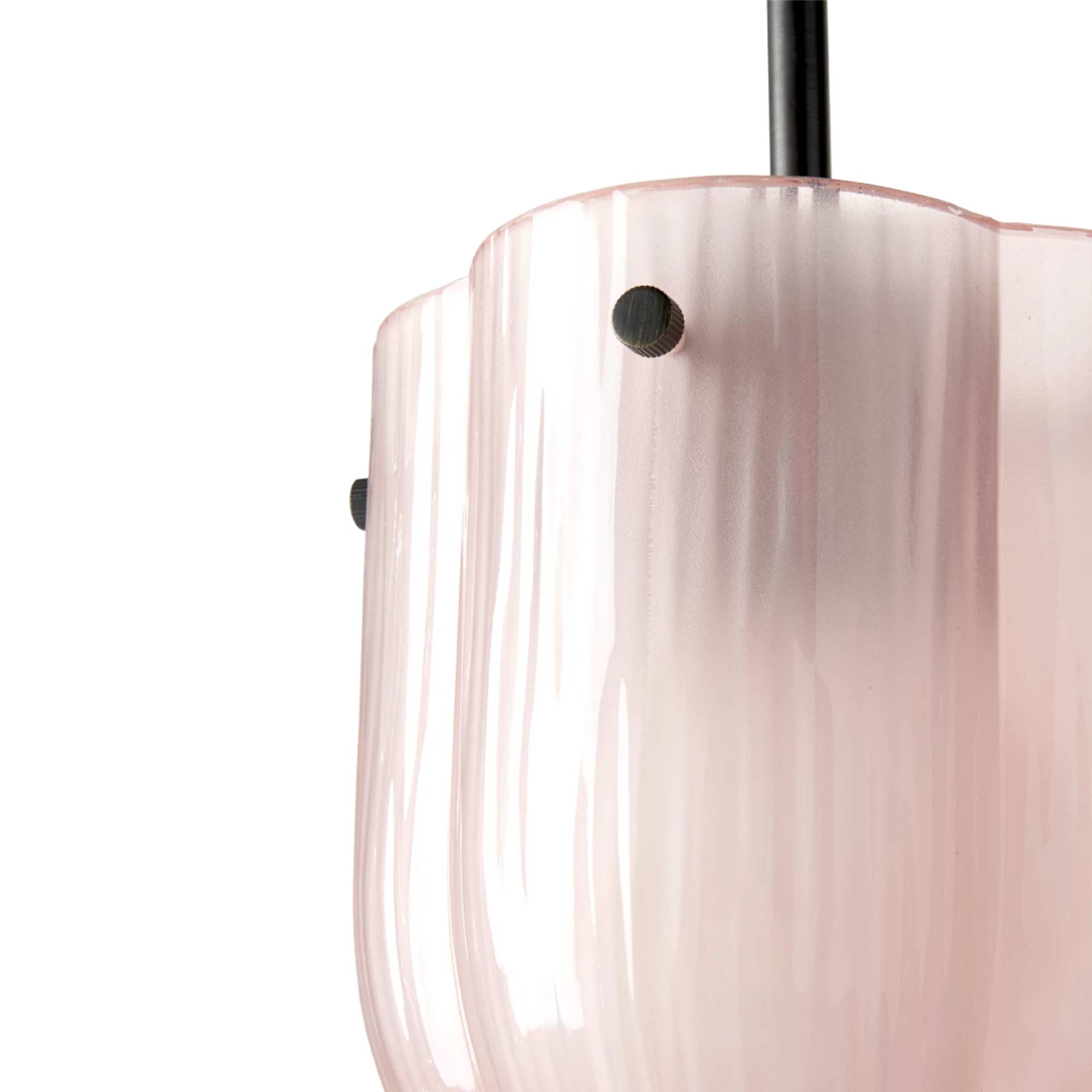 Close-up of a pale pink frosted glass pendant with a scalloped rim, black rod and small dark knobs