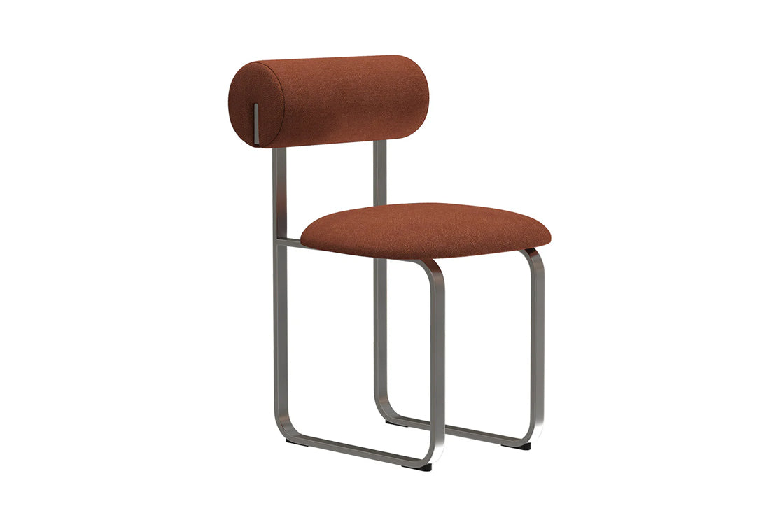Modern upholstered chair on steel legs against white background