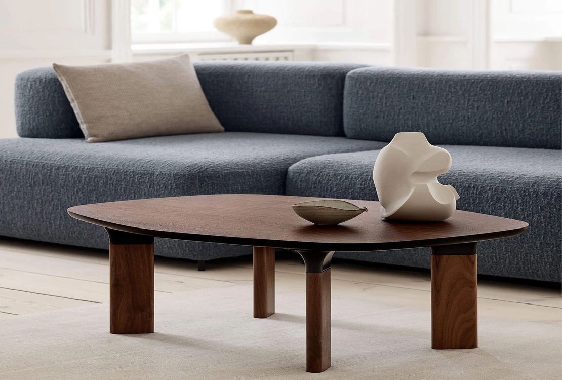 Wooden coffee table in front of blue sectional couch