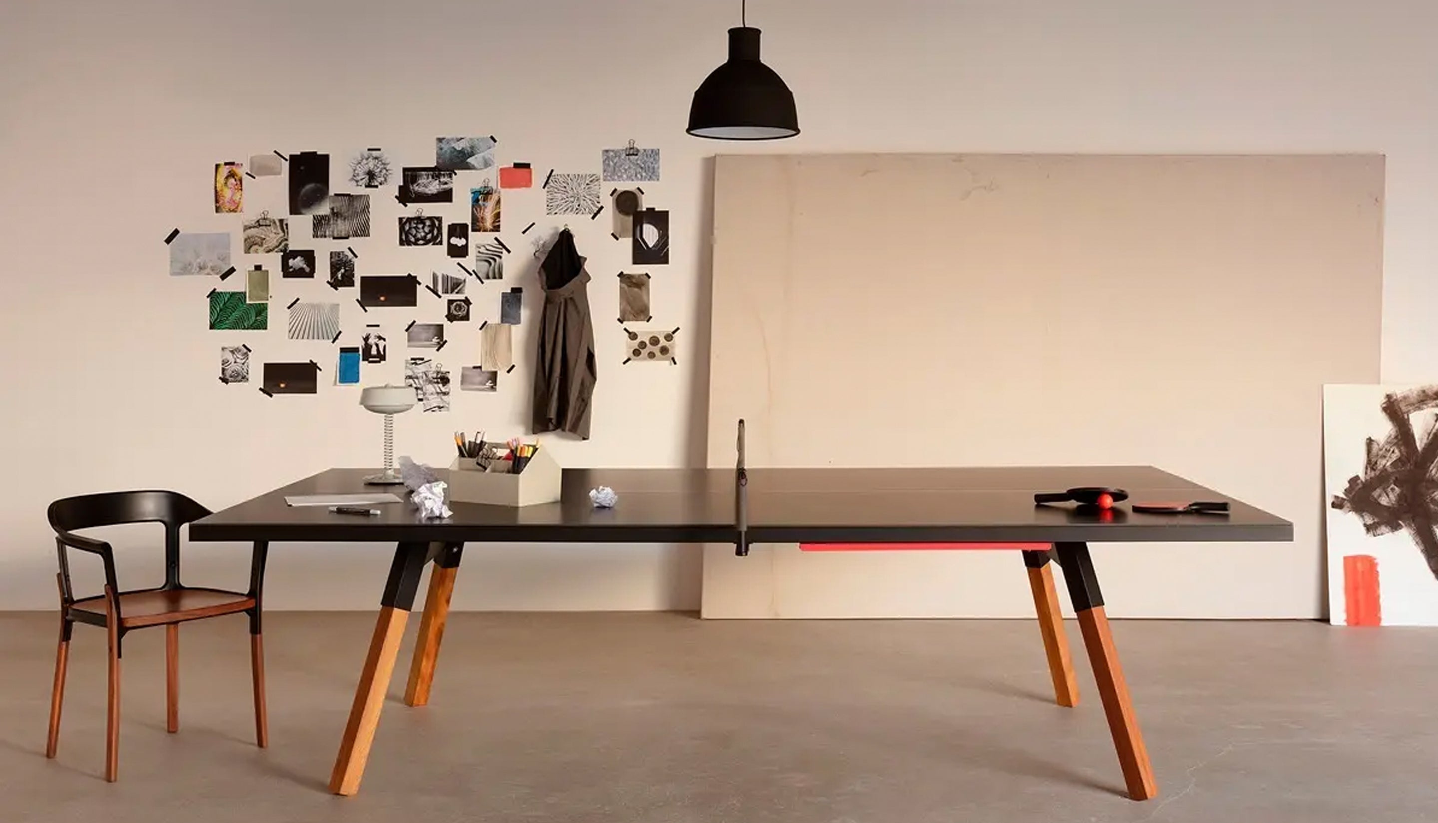 Modern dining table with wooden legs in a minimalistic room.