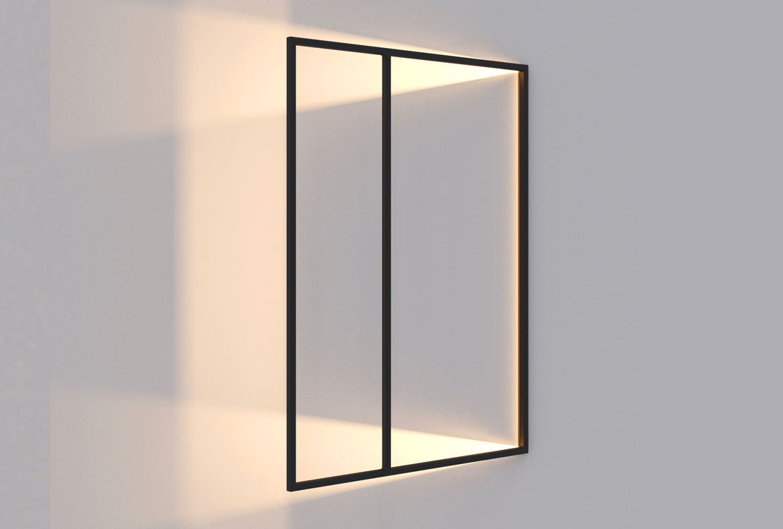 A modern rectangular wall light with a thin black metal frame and warm white LED lighting, mounted on a light gray wall.