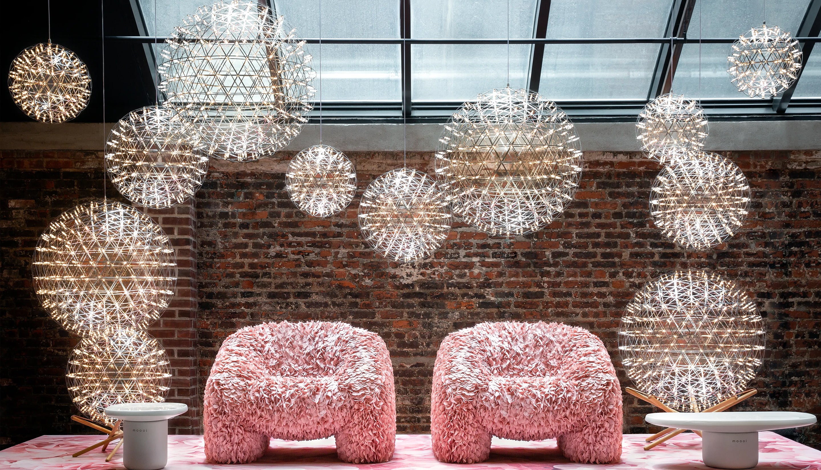 Pink chairs surrounded by spherical modern lights