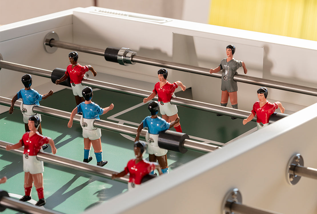 Close-up of a foosball table with player figures in action