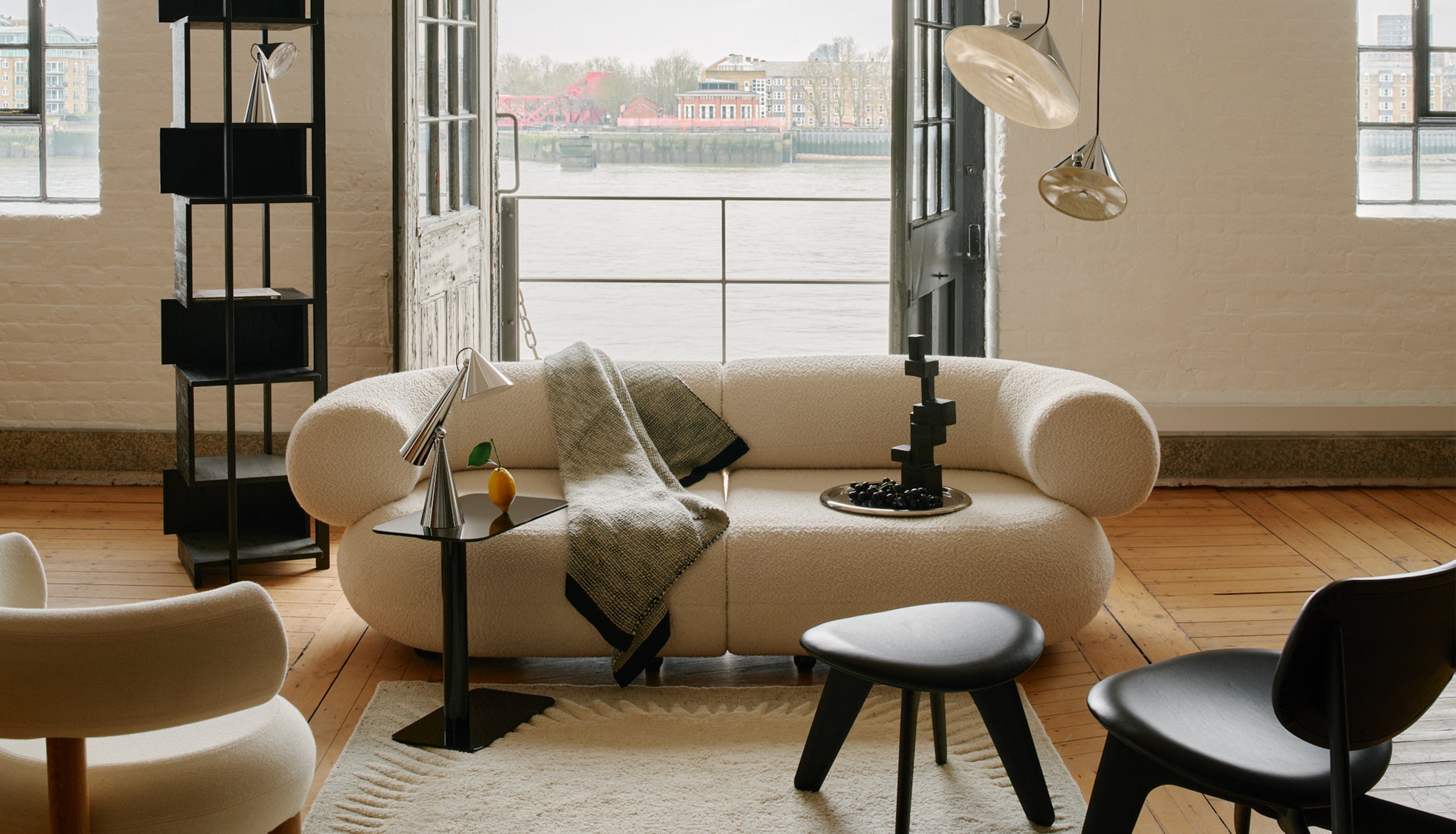 Modern living room with a beige sofa, armchair, and side table.