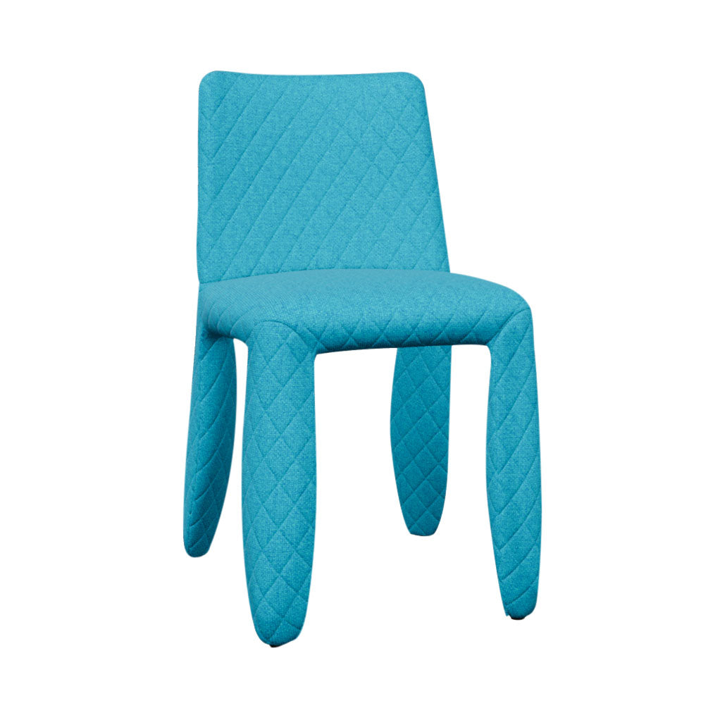 A dining chair fully covered in bright turquoise fabric with diamond quilting and thick rounded legs