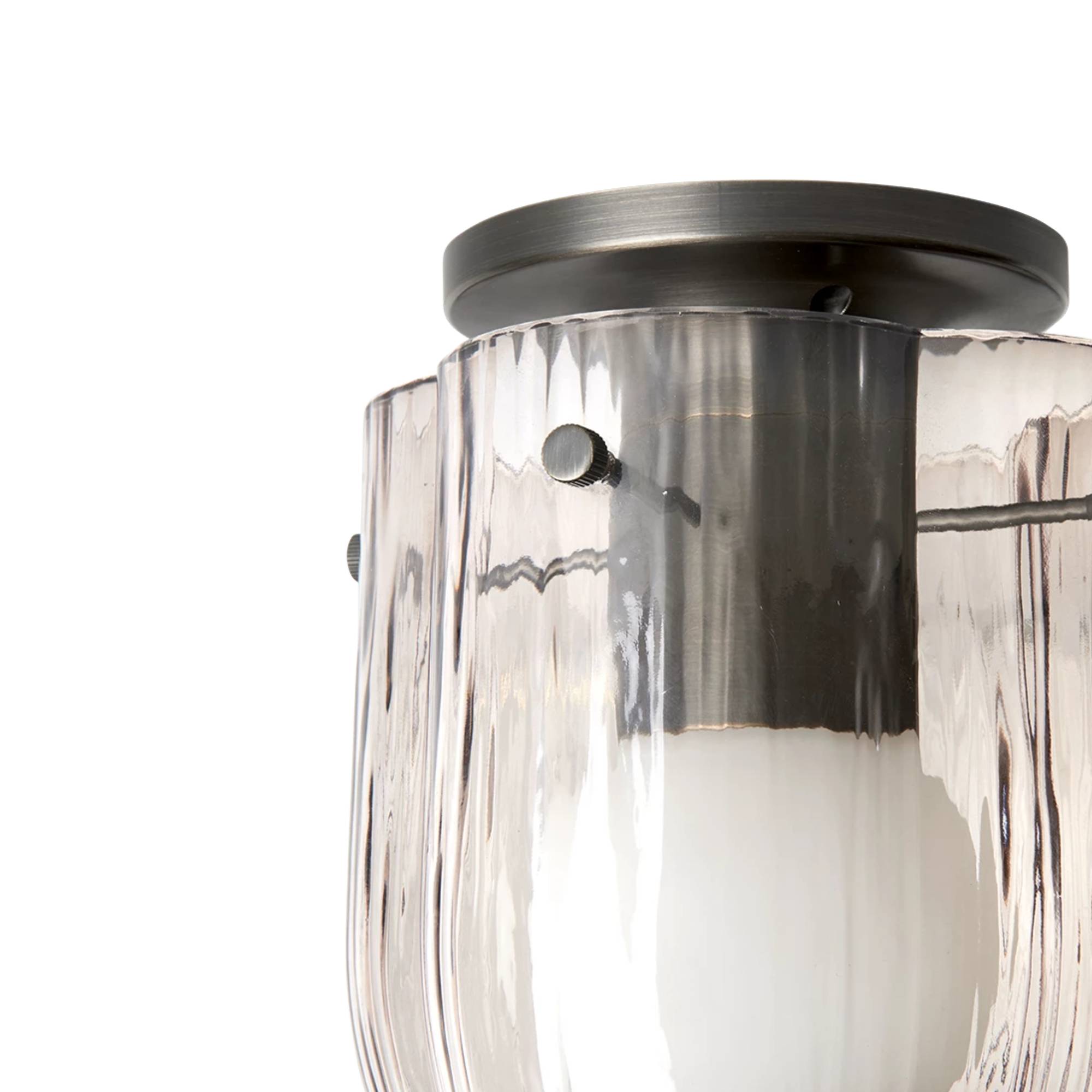 Close-up of a ceiling light with a dark metal round canopy and rippled blush-tinted glass panels around a white bulb
